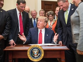 President Donald Trump speaks as he signs the Waters of the United States executive order, Tuesday, Feb. 28, 2017, in the Roosevelt Room in the White House in Washington. (AP Photo/Andrew Harnik)