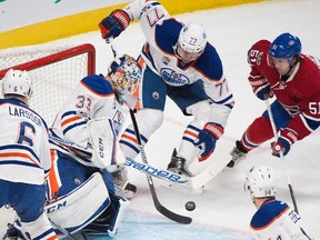 Montreal Canadiens' David Desharnais (51) moves in on Edmonton Oilers goaltender Cam Talbot as Edmonton's Oscar Klefbom (77), Jordan Eberle (14) and Adam Larsson (6) defend in Montreal on Feb. 5, 2017. (The Canadian Press)