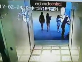 Leaked video surveillance footage shows Jonathan Chow (right) moments before he jumped over a railing to his death at a Singapore mall. Chow had hoped to shoot a Snapchat video. (Screengrab)