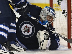 Winnipeg Jets goaltender Connor Hellebuyck has a shot from Minnesota Wild centre Eric Haula banked in off his shoulder in Winnipeg on Tues., Feb. 28, 2017. Kevin King/Winnipeg Sun/Postmedia Network