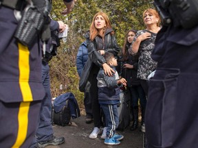 An extended family of 8 people from Colombia are detained by Royal Canadian Mounted Police officers after they illegally crossed the border near Hemmingford, Quebec, February 25 2017. (AFP PHOTO)