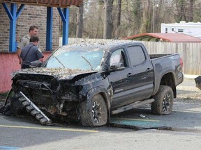 Cops look over what's left of a crashed Toyota Tacoma. (Will Robinson/Facebook photo)