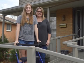 Riley Johnson, left, and her mother Peggy Johnson, right, stand in front of their Chatham house. Riley was diagnosed with chronic Lyme disease in 2016 after being misdiagnosed by numerous Ontario physicians. Now she and others like her are calling for better guidelines for testing and diagnosing Lyme.