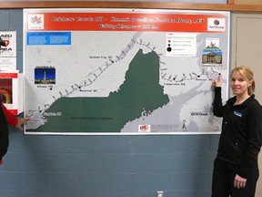 Bruce Bell/The Intelligencer
Ralph Hall and fitness instructor Tracy Powers of Fitness Powers are pictured with the map in the Wellington and District Community Centre for Commit to Walk, a 1,530-kilometre hike from Prince Edward County to Prince Edward Island.