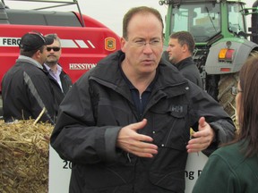 Andrew Richard, founder of Comet Biorefining, speaks with a visitor at a demonstration of corn stover collection and baling equipment the Cellulosic Sugar Producers Cooperative held in November near Forest. Comet Biorefining has announced completion of a round of equity financing for a plant it plans to build in Sarnia to turn corn stalks and leaves, and wheat straw, into sugar for industrial uses. (File photo)