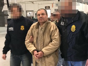 This file handout photo obtained on January 20, 2017, released by the Mexican Interior Ministry, shows Joaquin Guzman Loera aka ‘El Chapo’ Guzman escorted by the Mexican police as he is extradited to the United States. (Getty Images)