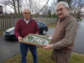 Herb Warren, chairman of the War Memorial Site Committee, holds up a model of the future Veterans Memorial Garden. The garden, which will be located in the green space on Moore Street in St. Thomas, will have the Great War soldier, the World War Two/Korean War Cenotaph and a new Afghanistan memorial located in it. (Laura Broadley/Times-Journal)