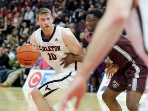 Carleton's Connor Wood is defended by Ottawa's Caleb Agada during the game between the Ravens and Gee-Gees on Feb. 3.