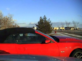RCMP are looking for a red 2014 Ford Mustang convertible with a black roof cover, bearing Alberta license plate BWH 6738