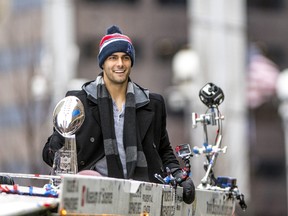 Jimmy Garoppolo of the New England Patriots holds the Vince Lombardi trophy during the Super Bowl victory parade on Feb. 7, 2017. (Billie Weiss/Getty Images)