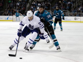 Brian Boyle of the Toronto Maple Leafs reaches for the puck next to San Jose Sharks' Micheal Haley during the second period Feb. 28, 2017, in San Jose, Calif. (MARCIO JOSE SANCHEZ/AP)