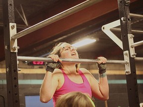 At the first CrossFit open last year, Keri-Ann Schedewitz rose above the bar during a set of chest-to-bar pull-ups.(Shaun Gregory/Huron Expositor)