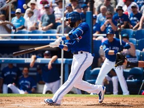 Toronto Blue Jays right fielder Jose Bautista (19) hits a foul ball against the Detroit Tigers during first inning Grapefruit baseball spring training action in Dunedin, Fla., on Wednesday, March 1, 2017. (THE CANADIAN PRESS/Nathan Denette)