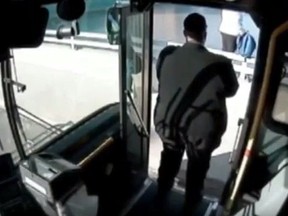 Dayton RTA driver Damone Hudson stands in the door of his bus talking to a suicidal woman. (Youtube screengrab)