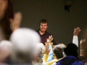 Oxford County farmer Tyler Vollmershausen asks the crowd questions during his presentation at Unifor Hall on Wednesday. (BRUCE CHESSELL/Sentinel-Review)