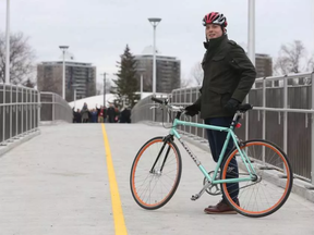 Bike lanes are planned for McArthur Avenue in Vanier. The lanes would connect to the Adàwe crossing, which opened in 2015, via the Rideau River Eastern Pathway. Here, Coun. Mathieu Fleury is pictured on the bridge. (Tony Caldwell, Postmedia)