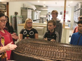 BRUCE BELL/THE INTELLIGENCER
Glanmore Historic Site acting curator Melissa Wakeling shows students from the Queen Elizabeth Grade 7-8 Student Leadership program a body basket on Thursday afternoon. As part of Takeover Day, the students will be running the museum on Saturday.