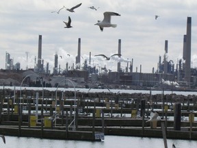 Seagulls fly over Sarnia Bay Marina on the St. Clair River Thursday in Sarnia, Ont., against the background of the industries of Chemical Valley. Following an incident last week that led to flaring at the Imperial Oil manufacturing site in Sarnia, an official on the Michigan side of the river is calling for improved communication during emergencies. (Paul Morden/Sarnia Observer)