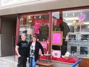 Pictured here are Janet Billson, who donated to the auction, and Betty Small, owner of Sally’s Closet. They are standing in front of the silent auction display in the store’s front window. (Justine Alkema/POSTMEDIA)