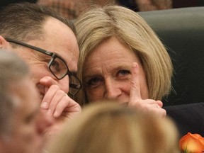 Alberta Finance Minister Joe Ceci and Alberta Premier Rachel Notley, speak to each other during the speech from the throne, in Edmonton on Thursday, March 2, 2017. THE CANADIAN PRESS/Jason Franson
