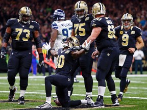 The word’s out that Saints wide receiver Brandin Cooks (kneeling) has been frustrated at not getting more receptions from 
QB Drew Brees (far right) because of the development of rookie receiver Michael Thomas, a rising star in the Big Easy. (AP)