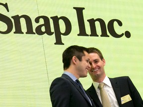 Snapchat co-founders Bobby Murphy, left, and CEO Evan Spiegel ring the opening bell at the New York Stock Exchange as the company celebrates its IPO, Thursday, March 2, 2017. (AP Photo/Richard Drew)