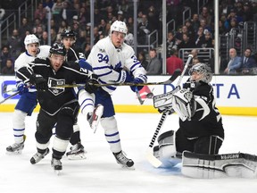 Auston Matthews battles for position in front of Kings goalie Jonathan Quick against defenceman Alec Martinez last night in L.A. The Leafs lost in a shootout after leading 2-0 heading into the third period. (Harry How, Getty Images)