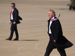 President Donald Trump walks across the tarmac at Langley Air Force Base in Hampton, Va., Thursday, March 2, 2017 after arriving on Air Force One for his first visit to the Hampton Roads area since taking office in January. The purpose of his visit was to deliver a speech in the hangar bay of the aircraft carrier Ford at Newport News Shipbuilding. (Bill Tiernan/The Virginian-Pilot via AP)