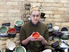 Oliver Page, a current London Potters Guild member, poses with a large assortment of handmade bowls, preparing them for the upcoming Empty Bowls event. (Photo submitted)