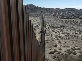 A truck drives near the Mexico-U.S. border fence, on the Mexican side, separating the towns of Anapra, Mexico and Sunland Park, New Mexico, on Jan. 25, 2017. (Christian Torres/AP Photo/Files)