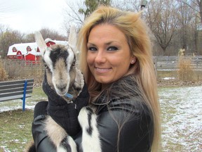 Stephanie Cook holds Marcel, a three-week-old goat kid, Friday at Canatara Park in Sarnia.Cook is organizing goat yoga classes at her farm in Brooke-Alvinston Township, and at DeGroot's Nurseries in Sarnia. Goat yoga is a trend that has spread in recent months from a farm in Oregon.  Paul Morden/Sarnia Observer/Postmedia Network
