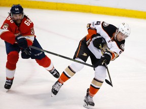 Anaheim Ducks defenceman Cam Fowler passes the puck as he is pursued by Florida Panthers right winger Jaromir Jagr during an NHL game on Feb. 3, 2017. (AP Photo/Wilfredo Lee)