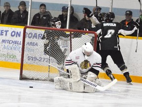 Three members of the Mount Forest Patriots celebrate a key third period goal behind Mitchell Hawks’ goalie Wyatt Nicholson last Thursday, March 2 in Game 7 of their PJHL Pollock division semi-final series. The Patriots, once down 3-0 in the best-of-seven series, rallied for four straight wins including the decisive 5-2 triumph. ANDY BADER/MITCHELL ADVOCATE