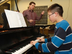 Evan Mitchell, Kingston Symphony musical director, works with young pianist Leonid Nediak on Thursday at Queen's University before Nediak’s performance on Sunday at the Isabel Bader Centre for the Performing Arts. (Julia McKay/The Whig-Standard)