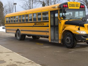 Sean Hunt of Ilderton holds his daughter Aubrey Hunt, 4 after she was dropped off at Oxbow PS by a school bus on Friday February 17, 2017. Hunt who lives in a new Ilderton subdivision has been told there's no room for their daughter at Oxbow and she will have to go to school at Valleyview PS in Coldstream. (MIKE HENSEN, The London Free Press)