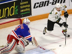 Robert Thomas of the Knights steals a puck in the corner and walks out in front of Kitchener goaltender Luke Richardson during their Friday night game at the Aud in Kitchener on Friday March 3, 2017. (MIKE HENSEN, The London Free Press)