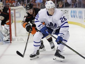 Toronto Maple Leafs' Nikita Soshnikov, center, of Russia, moves the puck under defense by Anaheim Ducks' Cam Fowler during the first period of an NHL hockey game Friday, March 3, 2017, in Anaheim, Calif. (AP Photo/Jae C. Hong)