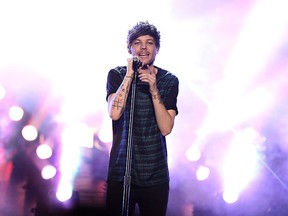 In this Nov. 22, 2015 file photo, Louis Tomlinson of One Direction performs at the American Music Awards at the Microsoft Theater on in Los Angeles. (Matt Sayles/Invision/AP)