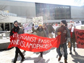 Around 40 people took part in a rally and march in support of immigrants and refugees and against Islamophobia and discrimination in downtown Sudbury on Saturday. The group was met by a handful of counter-protesters holding 'No M-103' signs in opposition to the federal government's recent anti-Islamophobia motion. Ben Leeson/The Sudbury Star/Postmedia Network