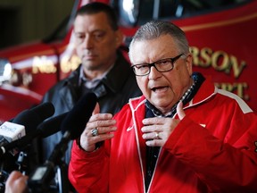 Ralph Goodale, Minister of Public Safety and Emergency Preparedness, speaks to media as Greg Janzen, Reeve of Emerson-Franklin listens in after a visit with officials at the fire hall in Emerson, Manitoba, Saturday, March 4, 2017. THE CANADIAN PRESS/John Woods