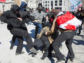 Anti-fascists, left, clash with opposing protesters during a demonstration regarding motion M-103 in Montreal, Saturday, March 4, 2017. THE CANADIAN PRESS/Graham Hughes ORG XMIT: GMH103
