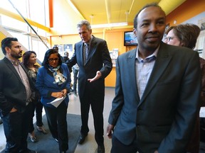 Manitoba Premier Brian Pallister meets with Rita Chahal, centre, Executive Director of Manitoba Interfaith Immigration Council (MIIC), at Welcome Place, a refugee support organization in Winnipeg, to announce emergency support for refugee claimants crossing the Manitoba border from the United States, Thursday, February 23, 2017. Pallister announced Manitoba's emergency support consisting of 14 housing units and $180,000 in funding to claimant supporting organizations. THE CANADIAN PRESS/John Woods