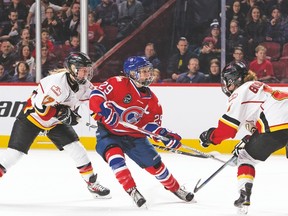 Women’s hockey superstar Marie-Philip Poulin of Montreal Les Canadiennes battles two Calgary Inferno players during a CWHL game. The two teams will meet for the Clarkson Cup and the league championship today at the Canadian Tire Centre. (CWHL photo)