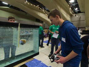 Joel Patterson maneuvers his powered submarine to try and touch a target at the other end of the aquarium at the 2017 APEGA Science Olympics at the Shaw Conference Centre on Saturday March 4, 2017 in Edmonton.   Greg  Southam / Postmedia