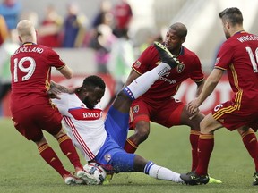 Real Salt Lake midfielder Luke Mulholland, Chris Schuler and d Chris Wingert (16) defend Toronto FC forward Jozy Altidore as he falls to the pitch during an MLS soccer game, Saturday, March 4, 2017 in Sandy, Utah. (Scott G. Winterton/The Deseret News via AP)