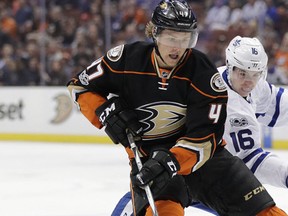 Anaheim Ducks' Cam Fowler, left, and Toronto Maple Leafs' Mitchell Marner fight for the puck during the first period of an NHL hockey game Friday, March 3, 2017, in Anaheim, Calif. (AP Photo/Jae C. Hong)