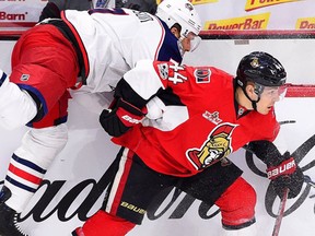 Ottawa Senators centre Jean-Gabriel Pageau hits Columbus Blue Jackets defenceman Jack Johnson during first period NHL hockey action in Ottawa on Saturday, March 4, 2017. (THE CANADIAN PRESS/Sean Kilpatrick)
