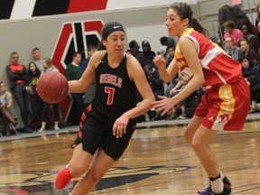 Makenna Ledgister of the Jasper Place Rebels, left, drives to the rim against an opponent with the Scona Lords in the senior women's high school basketball final on Saturday.