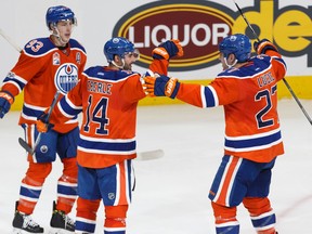 Edmonton's Jordan Eberle (14) celebrates his goal with Andrej Sekera (2) and Ryan Nugent-Hopkins (93) during the third period of a NHL game between the Edmonton Oilers and the Detroit Red Wings at Rogers Place in Edmonton on Saturday, March 4, 2017.