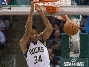 Milwaukee Bucks' Giannis Antetokounmpo dunks the ball as Toronto Raptors' Serge Ibaka looks on during the first half of an NBA basketball game Saturday, March 4, 2017, in Milwaukee. (AP Photo/Tom Lynn)